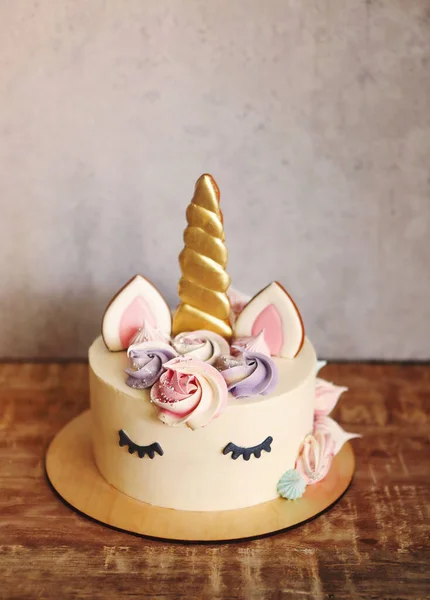 Beautiful bright cake in the form of a unicorn with cream colore