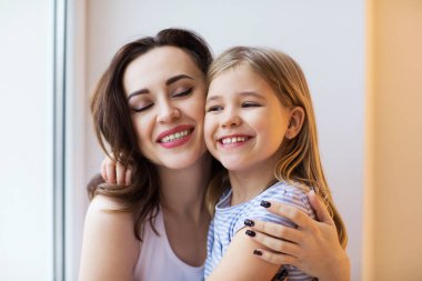 Kızına sarılan genç bir kadın. Aşk ve aile kavramı 