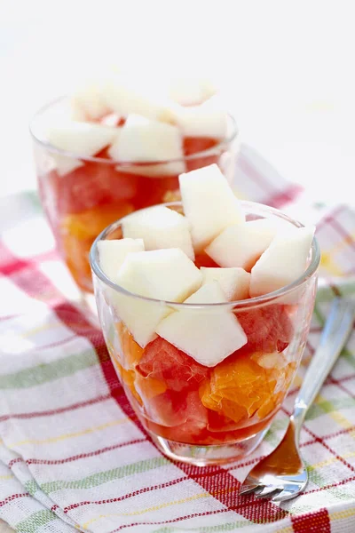健康而新鲜的色泽艳丽的甜点 用切好的新鲜水果制成 放在玻璃杯上 餐叉用亚麻布 背景为白色 — 图库照片