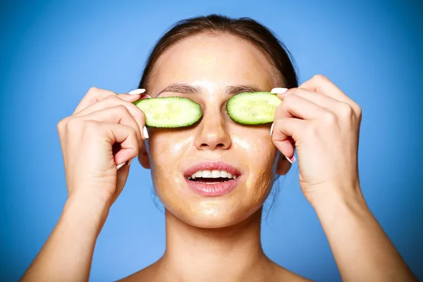 Happy Relaxed Female Brown Cosmetic Cream Cucumber Facial Mask Blue — Stock Photo, Image