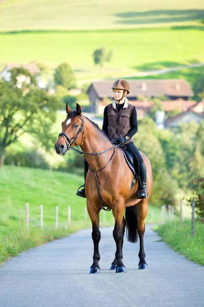 Mujer joven monta a caballo en verano . —  Fotos de Stock