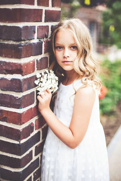 Portret mody pięknej 9 -10 lat dziewczyna w białej sukience i pozowanie w parku. — Zdjęcie stockowe