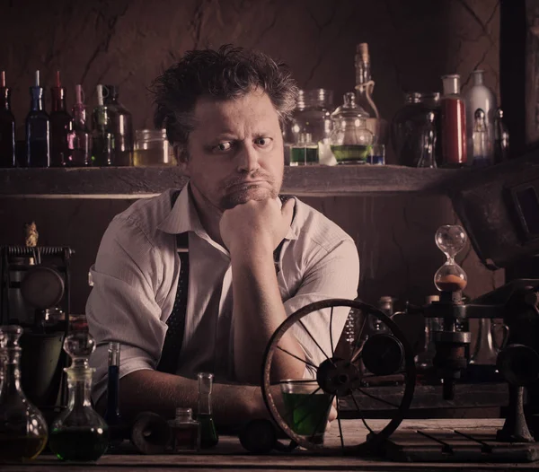 Crazy medieval scientist working in his laboratory — Stock Photo, Image