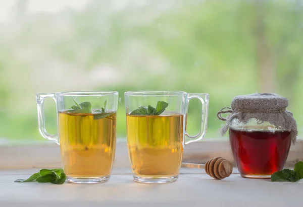 Tea in glass cup on old  windowsill — Stock Photo, Image