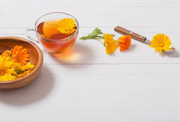 Beyaz ahşap masa Calendula (kadife çiçeği) bitkisel çay — Stok fotoğraf