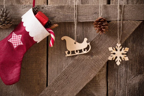 Bas de Noël avec des cadeaux sur le mur en bois — Photo