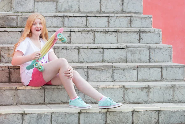 Girl teenager with skateboard on stairs — Stock Photo, Image