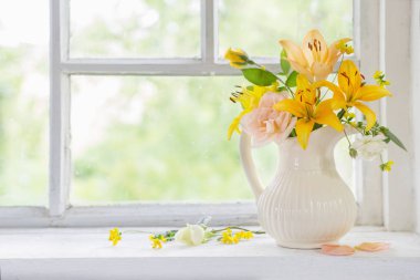 Vazodaki çiçekler pencere pervazında