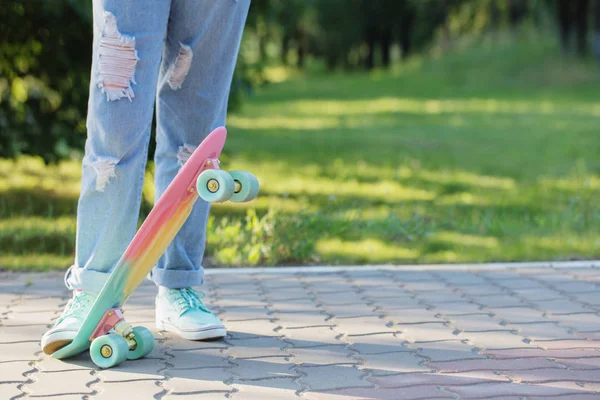 Teen girl down the street with a skateboard — Stock Photo, Image