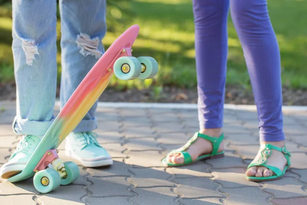 Teen girl down the street with a skateboard — Stock Photo, Image