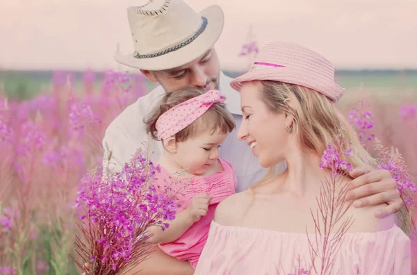 Happy family in flowers meadow — Stock Photo, Image