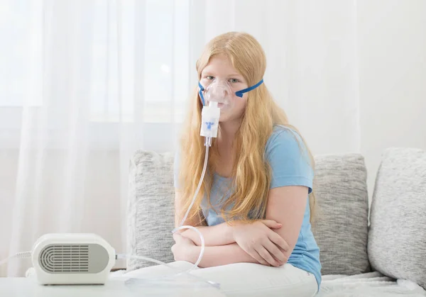 Teenager girl doing inhalation indoor — Stock Photo, Image