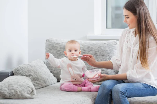 Mom feeding baby indoor — Stock Photo, Image