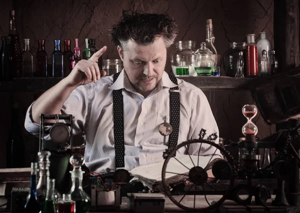 Crazy medieval scientist working in his laboratory — Stock Photo, Image