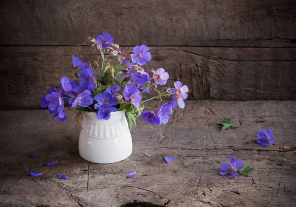 Blue flowers on old wooden background — Stock Photo, Image