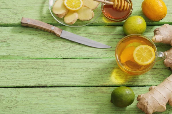 Ginger tea and ingredients on a  grunge wooden background — Stock Photo, Image