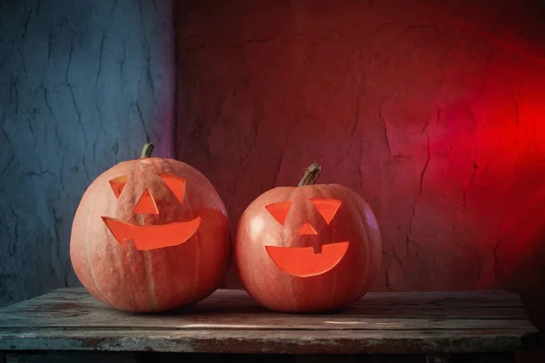 Halloween pumpkins on wooden table on dark background — Stock Photo, Image