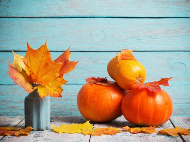 sonbahar yaprakları ve kabaklar mavi ahşap zemin üzerine