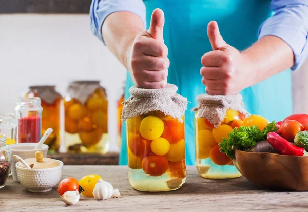 Men with vegetables in jars — Stock Image Men with vegetables in jars Stock Photo