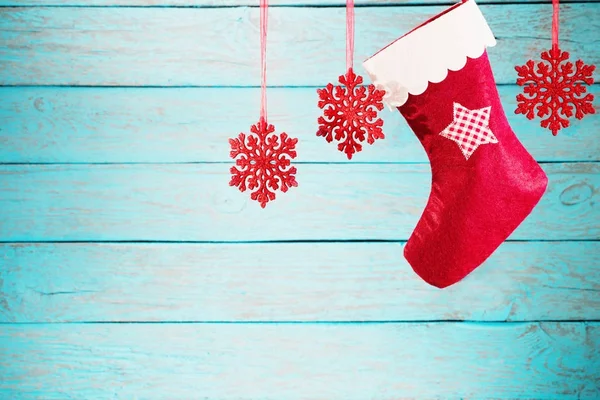 Christmas stocking hanging against wooden background — Stock Photo, Image