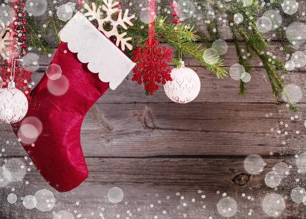 Christmas stocking hanging against wooden background — Stock Photo, Image