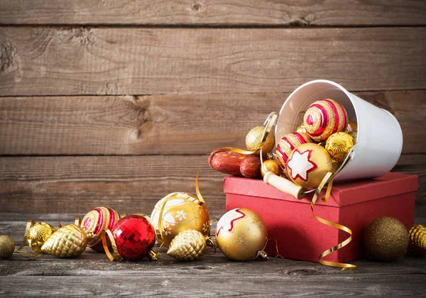 Christmas toys and red box on old wooden background — Stock Photo, Image