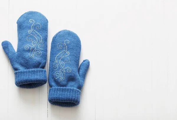 Blue mittens on white wooden background — Stock Photo, Image
