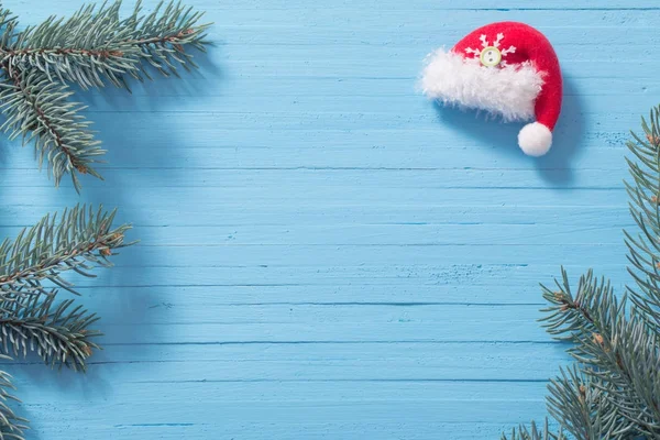 Red santa hat on blue wooden background — Stock Photo, Image