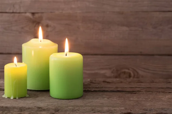 Velas verdes sobre fondo de madera oscura —  Fotos de Stock