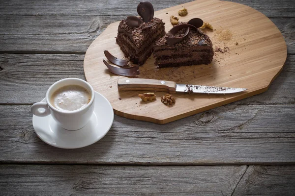 Chocolate cake on old wooden table — Stock Photo, Image