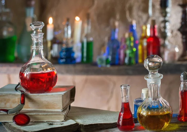 Magic potion, ancient books and candles — Stock Photo, Image