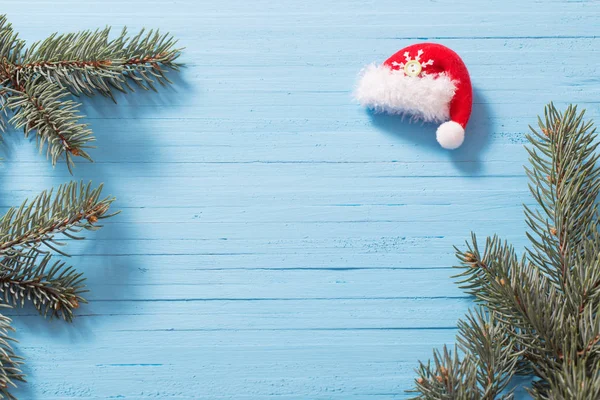 Red santa hat on blue wooden background — Stock Photo, Image