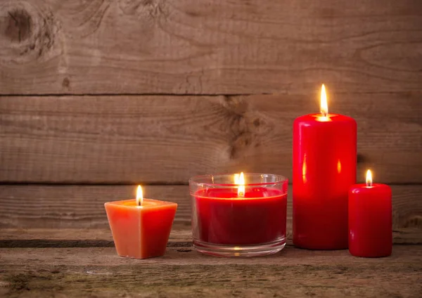 Червоні свічки на темному дерев'яному фоні — стокове фото