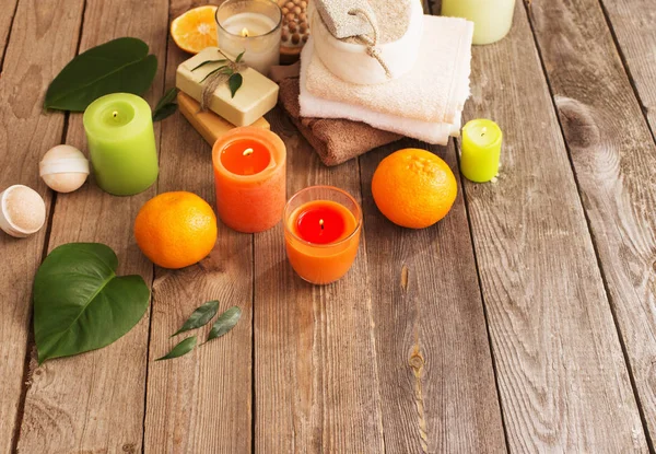 Spa concept with orange fruits on old wooden background — Stock Photo, Image