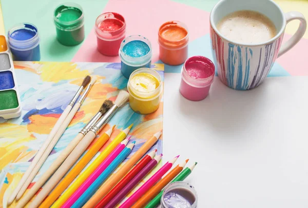 Cup of coffee and paints, pencils on white background — Stock Photo, Image