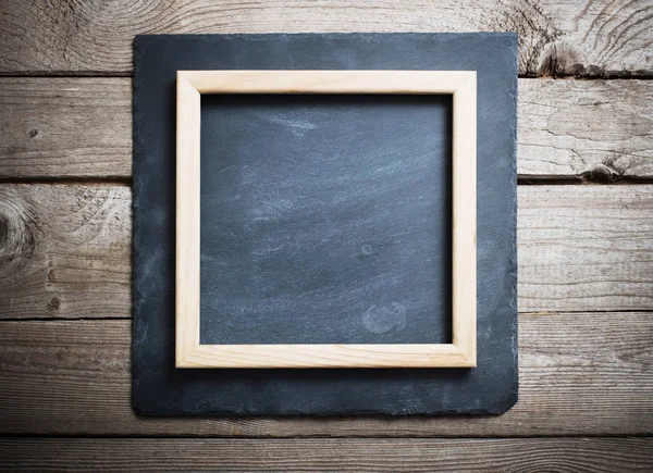 Old wooden background with black stone board — Stock Photo, Image