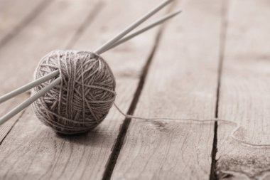 Örgü ve örgü iğneleri bir ahşap yüzeye