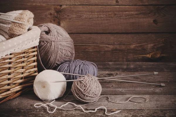 Knitting and knitting needles on a wooden surface — Stock Photo, Image