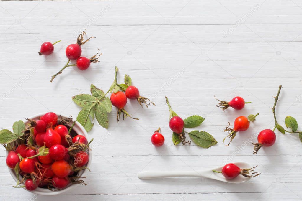 berries of a dogrose on a wooden background