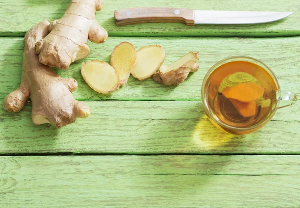 Ginger tea and ingredients on a  grunge wooden background — Stock Photo, Image