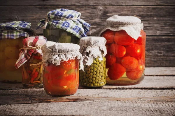 Preserved vegetables in jar on old wooden background — Stock Image Preserved vegetables in jar on old wooden background Royalty Free Stock Photos