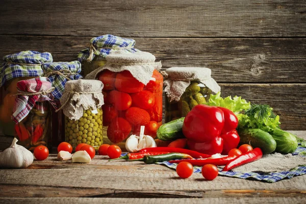 Preserved vegetables in jar on old wooden background — Stock Image Preserved vegetables in jar on old wooden background Royalty Free Stock Images
