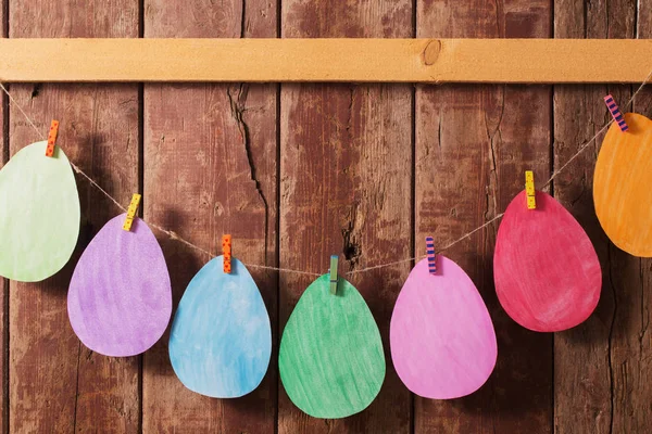 Easter paper eggs on wooden background — Stock Photo, Image