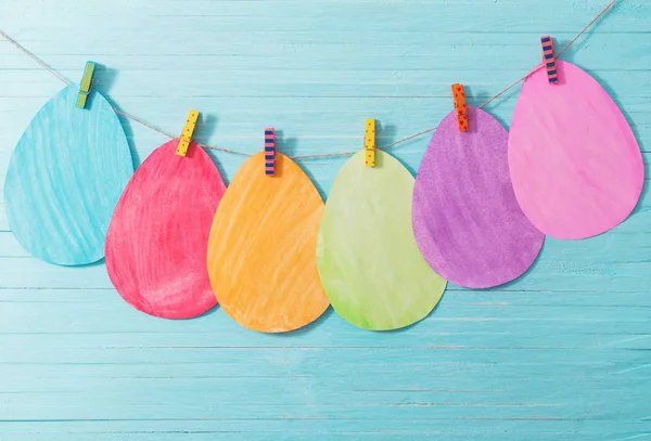 Easter paper eggs on wooden background — Stock Photo, Image