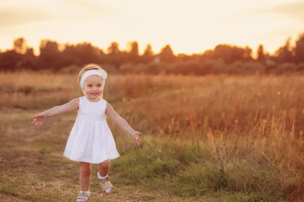 Little girl in white dress outdoor — Stock Photo, Image