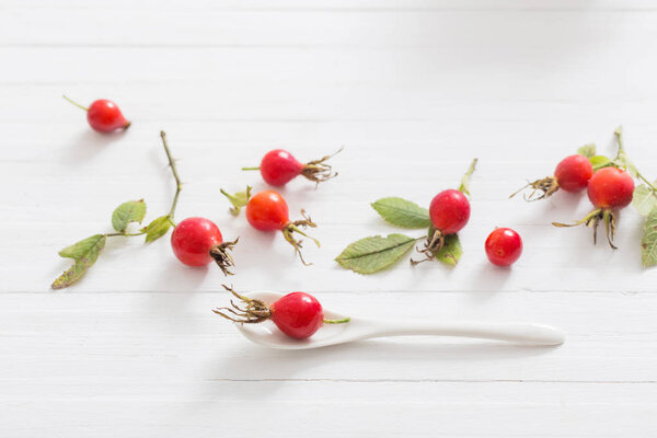 berries of a dogrose on a wooden background