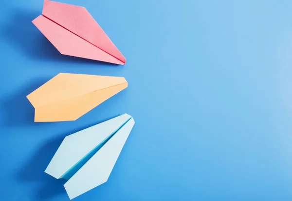 Paper plane on blue color background — Stock Photo, Image