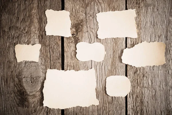 Old paper on wooden background — Stock Photo, Image