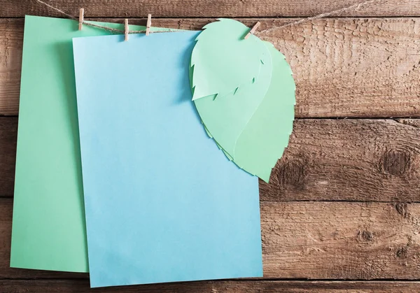 Paper sheets on old wooden background — Stock Photo, Image