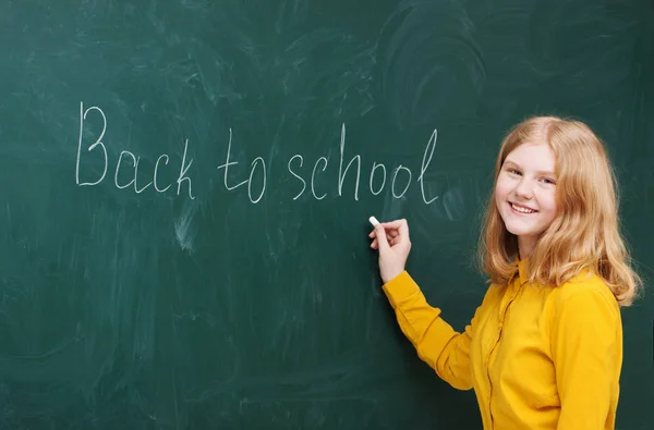 Schoolgirl at the blackboard — Stock Photo, Image